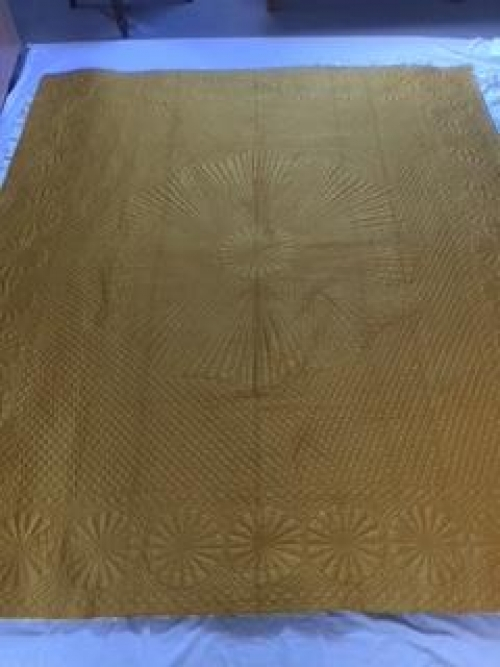 Gold quilt with stitched design
