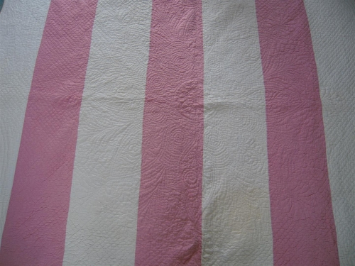 Pink and white striped quilt