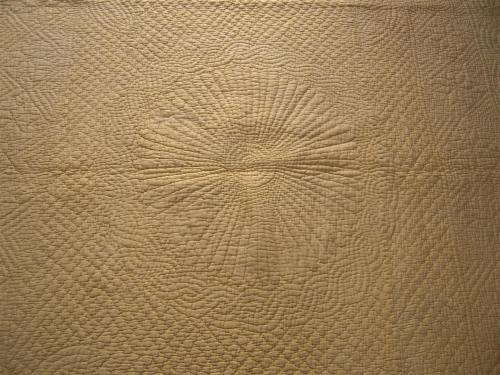 Stitched centre design on yellow quilt