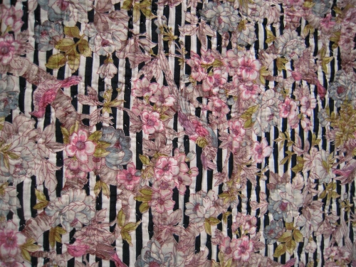 black and white narrrow striped fabric with a pink and white floral design