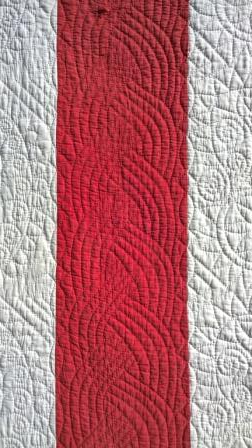 red and white quilt detail with cable design