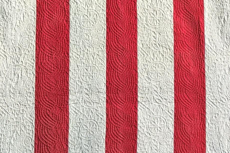Red and white strippy quilt