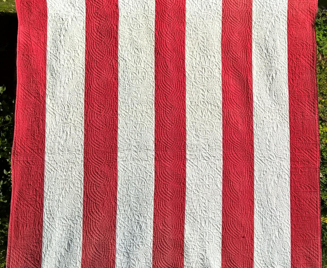 Red and white strippy quilt