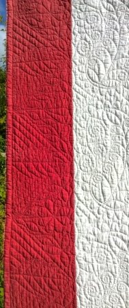 Red and white quilt detail of edge