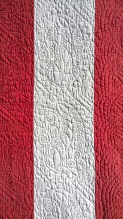 Red and white strippy quilt detail
