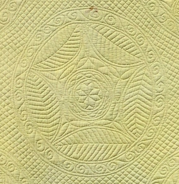 Stitched ring of five large, beech leaves leaving a five-pointed star shape within.