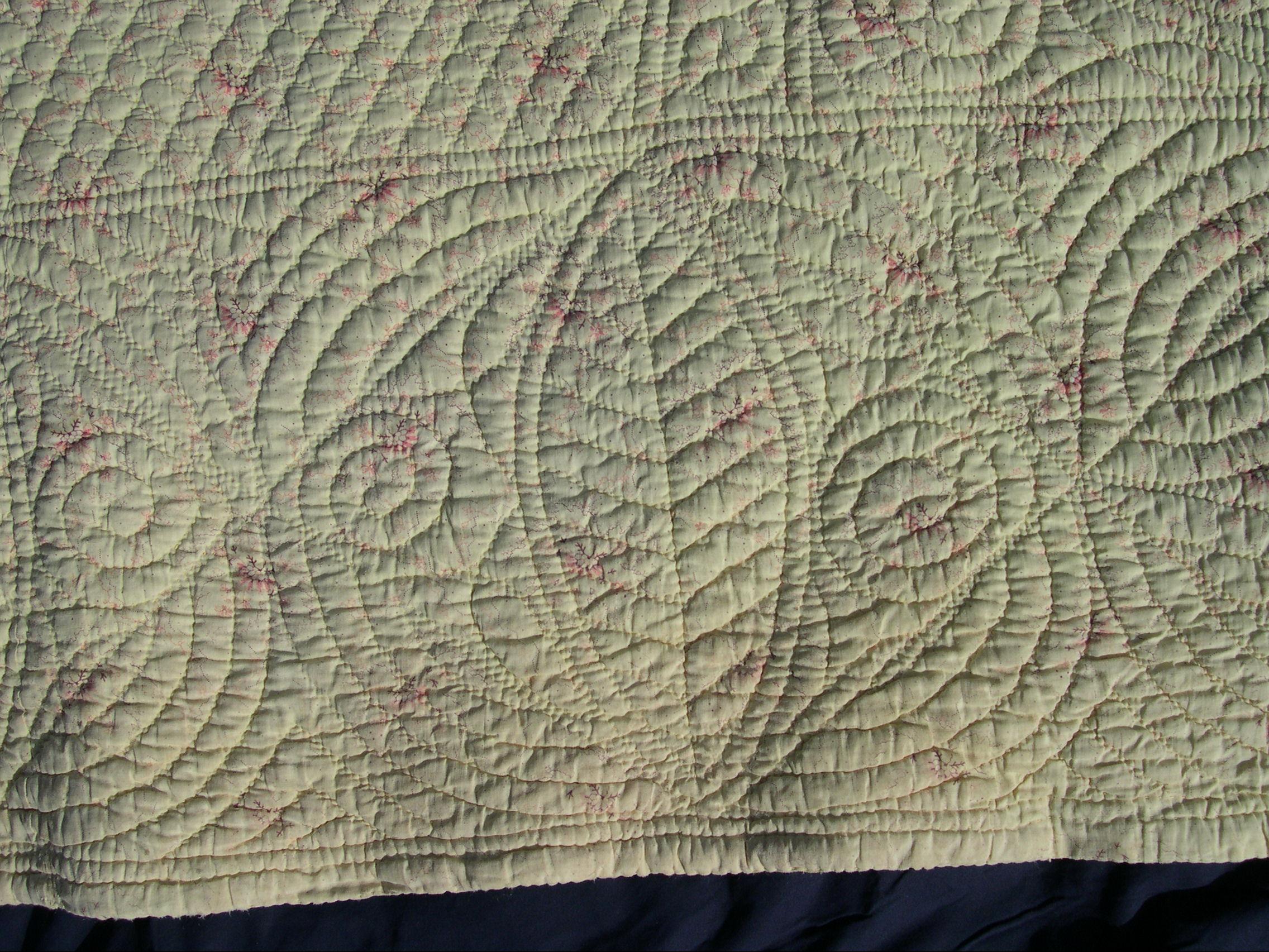 Delicate pink on cream print fabric on back of quilt