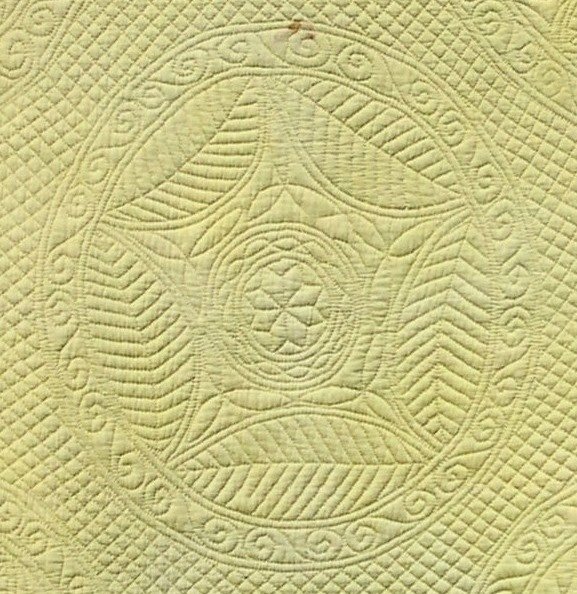 Stitched ring of five large, beech leaves leaving a five-pointed star shape within.