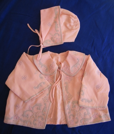 Pale pink baby's jacket and bonnet