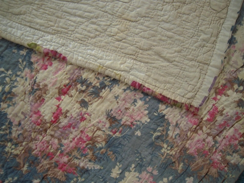 Pink flowers on blue quilt