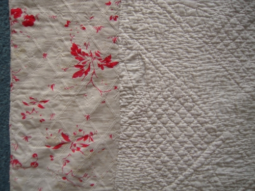 Red and white pattern fabric on edge of quilt