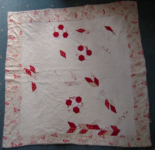 White quilt with random red patches