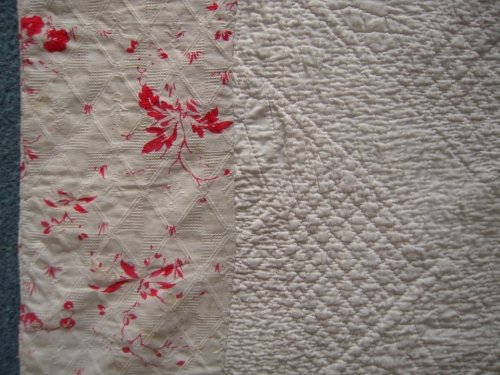 Red and white pattern fabric on edge of quilt