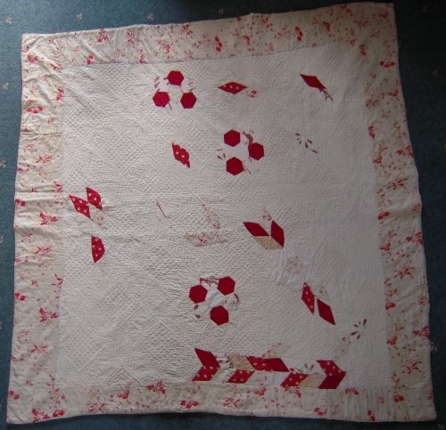 White quilt with random red patches