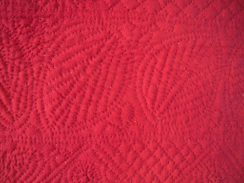 Detail of stitching red quilt