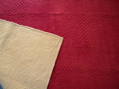 Red quilt with cream corner turned over