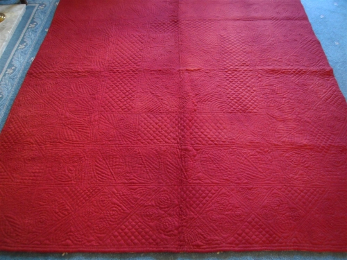 Red quilt on floor