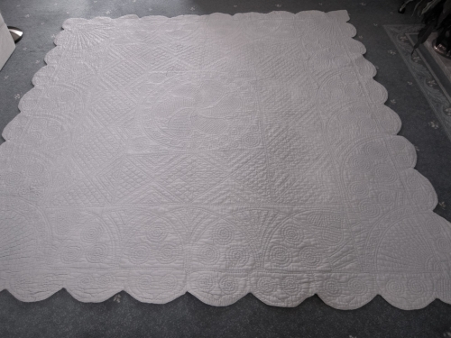 pale blue quilt on floor