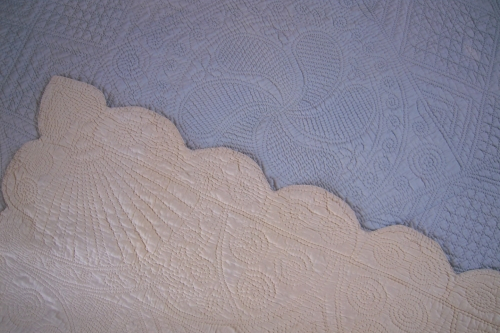 Blue quilt with cream turned over corner