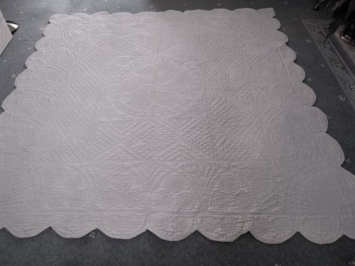 pale blue quilt on floor