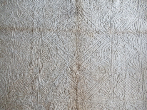 quilting design on white reverse of quilt