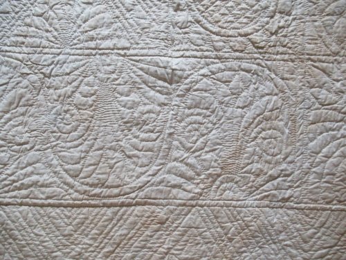Detail of quilting on white reverse
