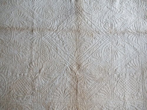 quilting design on white reverse of quilt