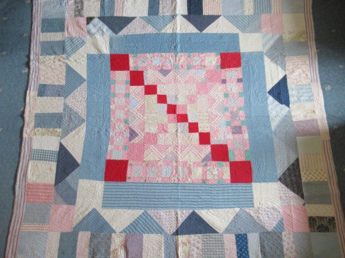 Patchwork quilt in pinks , blues and creams