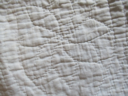 cream back of quilt quilting detail