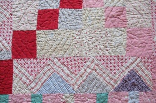 Patchwork quilt detail in pinks and creams