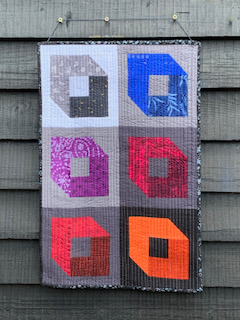 Hollow Boxes quilt, featuring colourful 3D-like boxes
