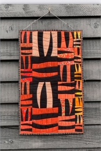 Tiger Tiger quilt, featuring bold stripes and geometric shapes in a vibrant color palette