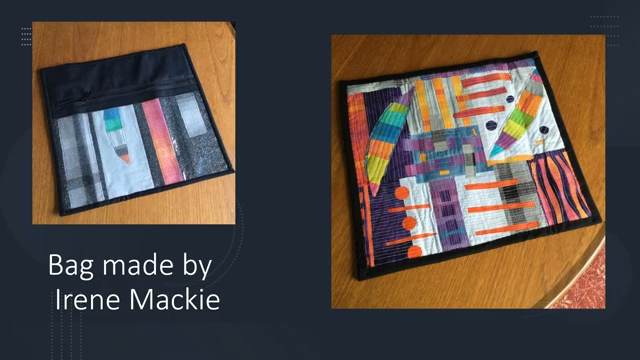 A square quilted bag with black binding and a colourful, abstract design featuring geometric shapes and stripes.