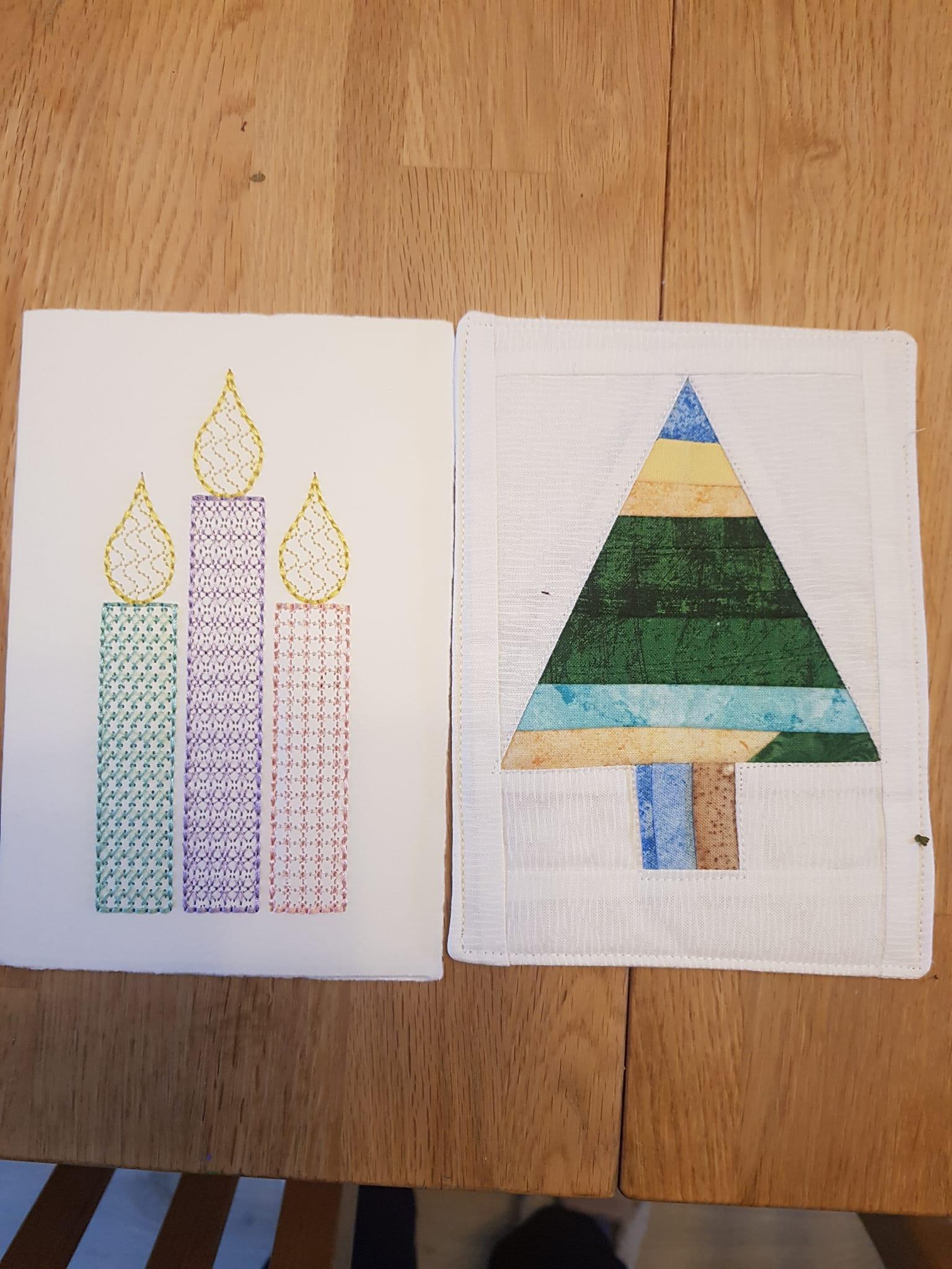 Image 1: A square quilt with a white background. The quilt features four candles of different colours: yellow, green, purple, and red. Each candle has a flame at the top. The candles are embroidered with a simple line design. Image 2: A square quilt with a white background. The quilt features a Christmas tree made up of different coloured fabric strips. The tree has a brown trunk and a star on top.