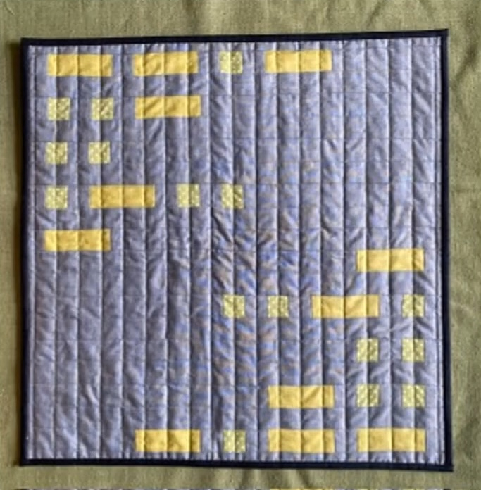 A square quilt with a purple background. The quilt features a pattern of yellow rectangles of varying sizes, arranged in a grid-like fashion. The background is quilted with a linear pattern. The quilt has a black binding..