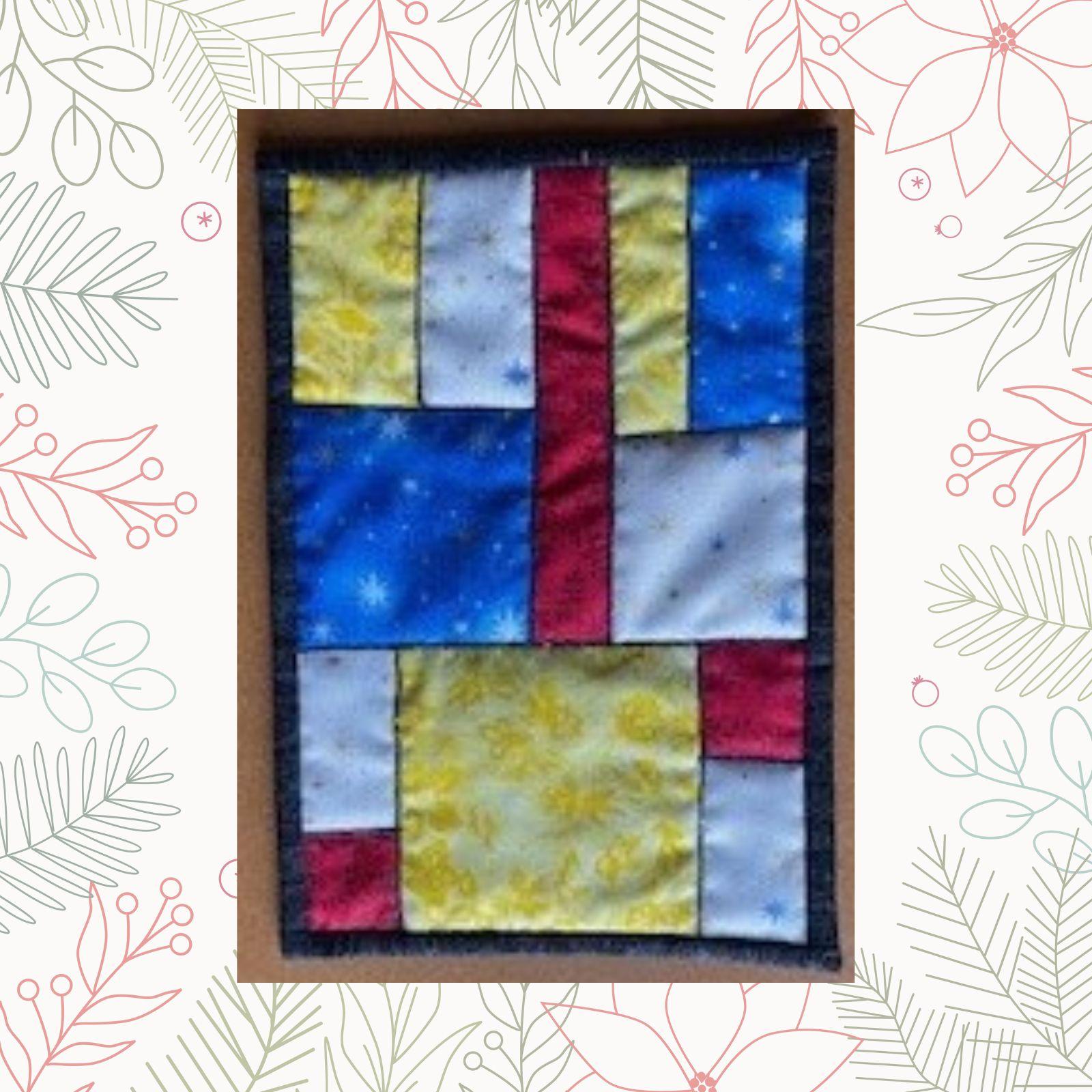 A rectangular quilt with a patchwork design. The quilt features squares in various colors, including blue, red, white, and yellow. The squares have different patterns, such as stars and dots.