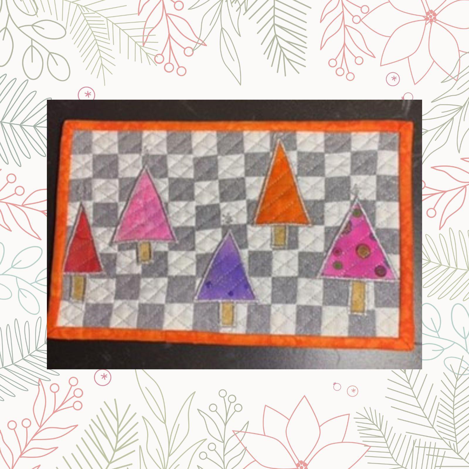 A rectangular quilt with a gray and white checkered background and an orange border. The quilt features five colorful Christmas trees in various shades of pink, purple, and orange. The trees have brown trunks. The background is quilted with a linear pattern.
