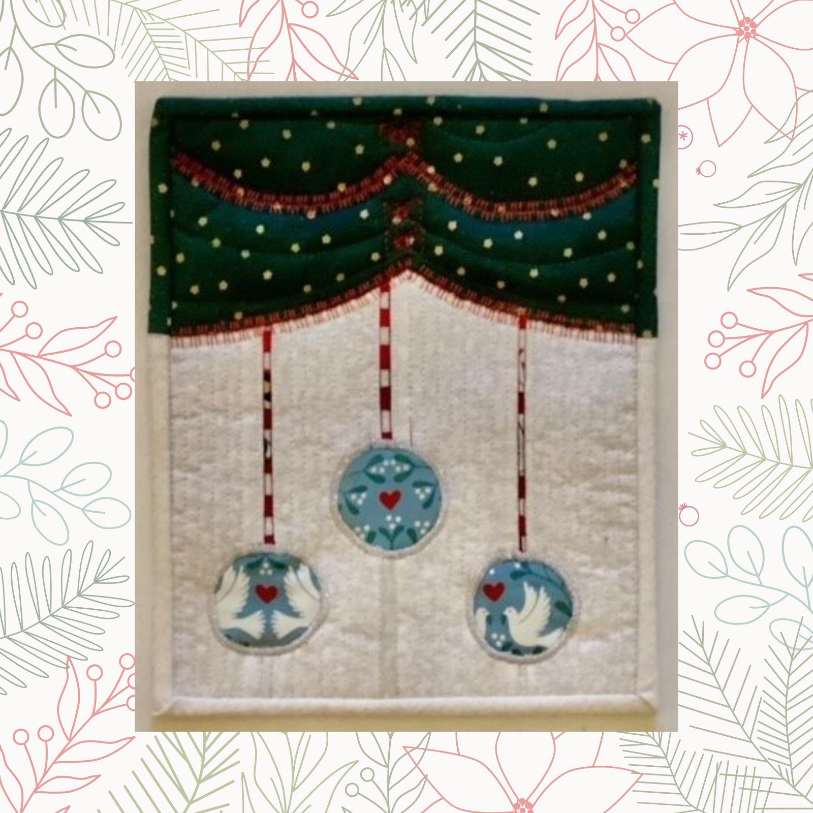 A square quilt with a green background and a white border. The quilt features a blue curtain-like design with three hanging ornaments. Each ornament is decorated with a pair of doves. The background is quilted with a linear pattern.