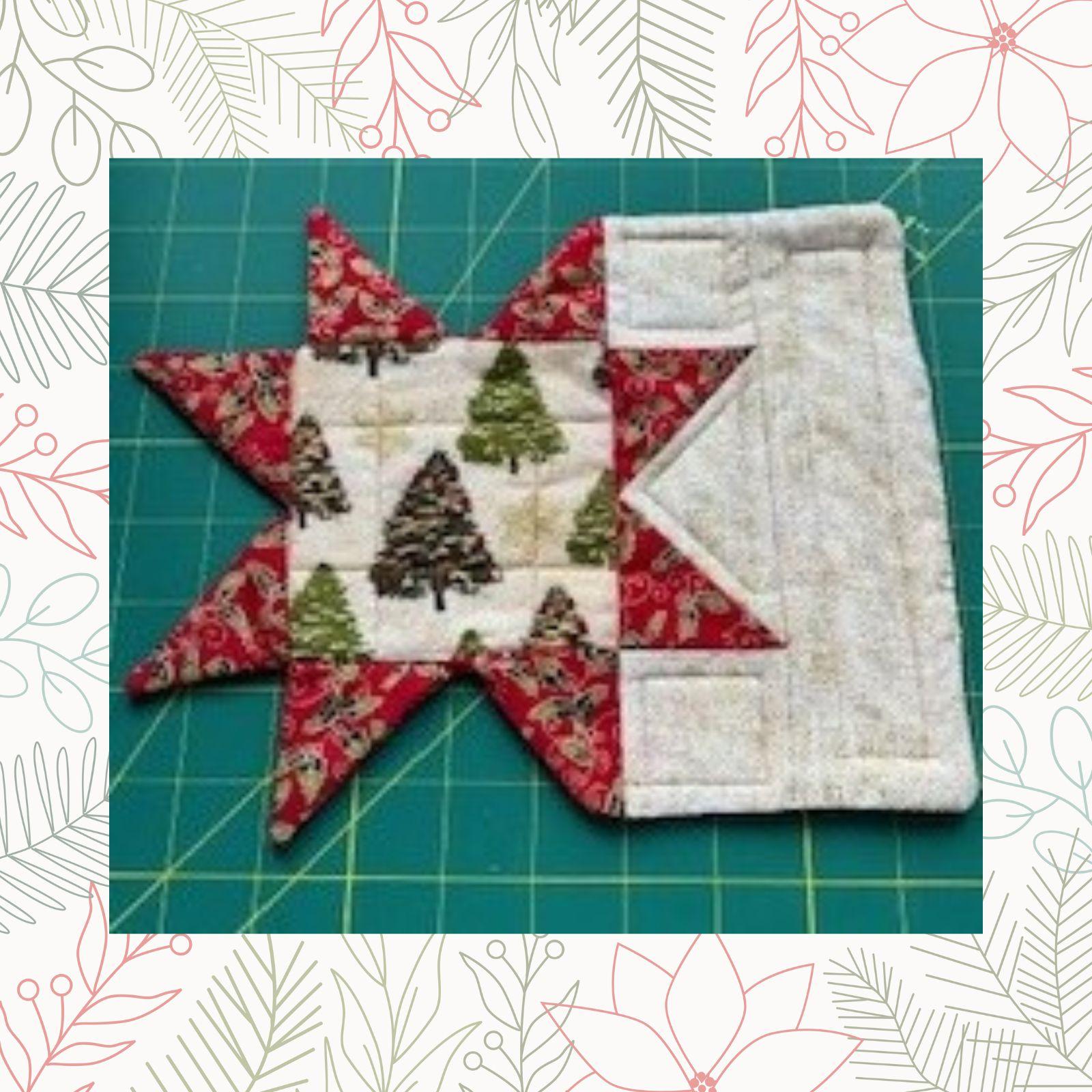A close-up of a star-shaped quilt block. The block is made up of red and white fabric pieces, with a central section featuring a Christmas tree pattern.