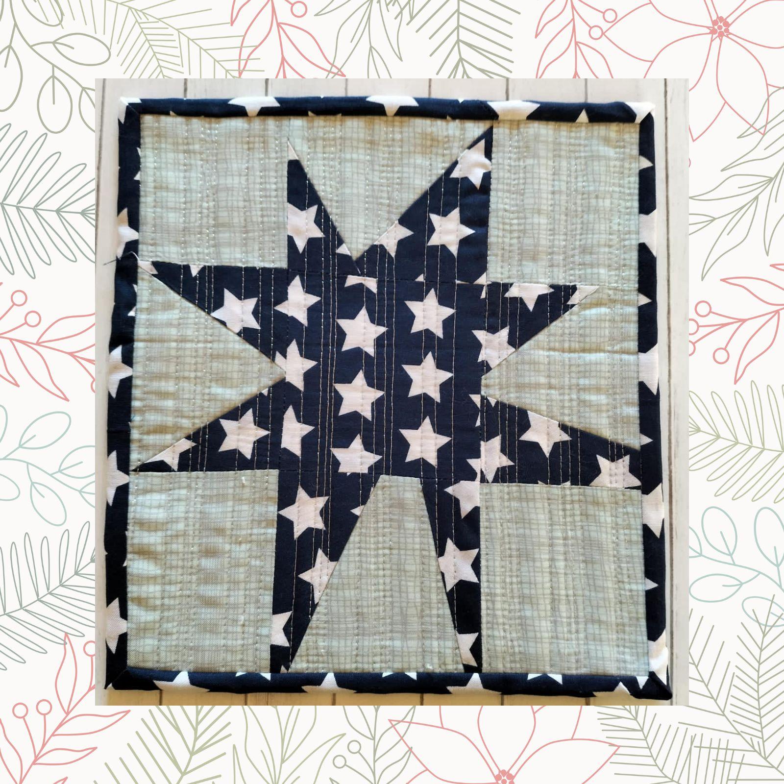 A square quilt with a blue background and a white border. The quilt features a large, white star shape in the center, made up of smaller star-shaped pieces. The background is quilted with a linear pattern.