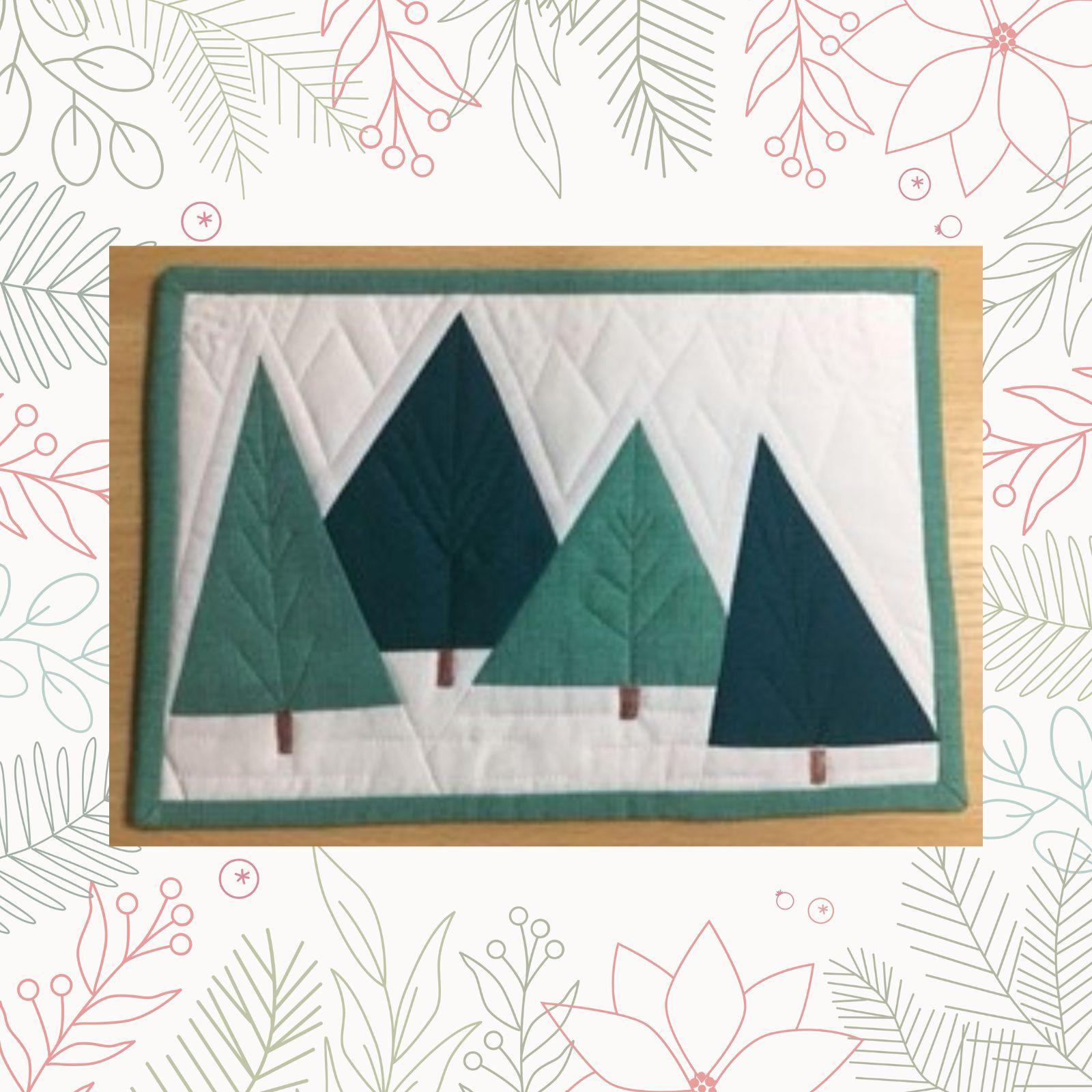 A rectangular quilt with a white background. The quilt features four Christmas trees of different sizes, made from green fabric. The trees are arranged in a row and have brown trunks. The background is quilted echoing the shapes of the trees.