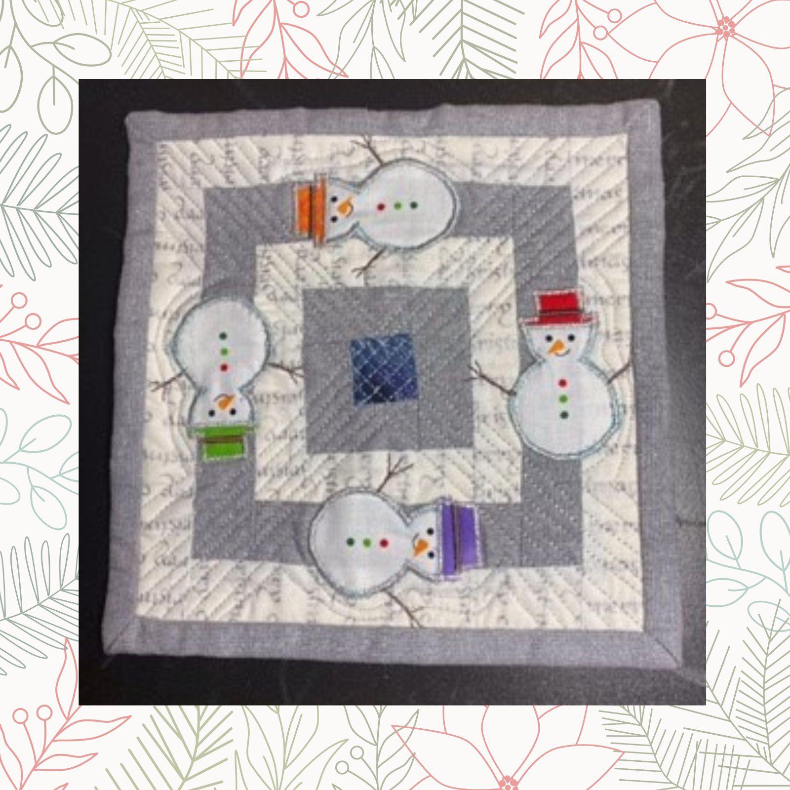 A square quilt with a gray background. The quilt features four snowmen arranged in a square pattern. Each snowman has a different colored hat and scarf. The background is quilted with a linear pattern. The quilt has a gray border.