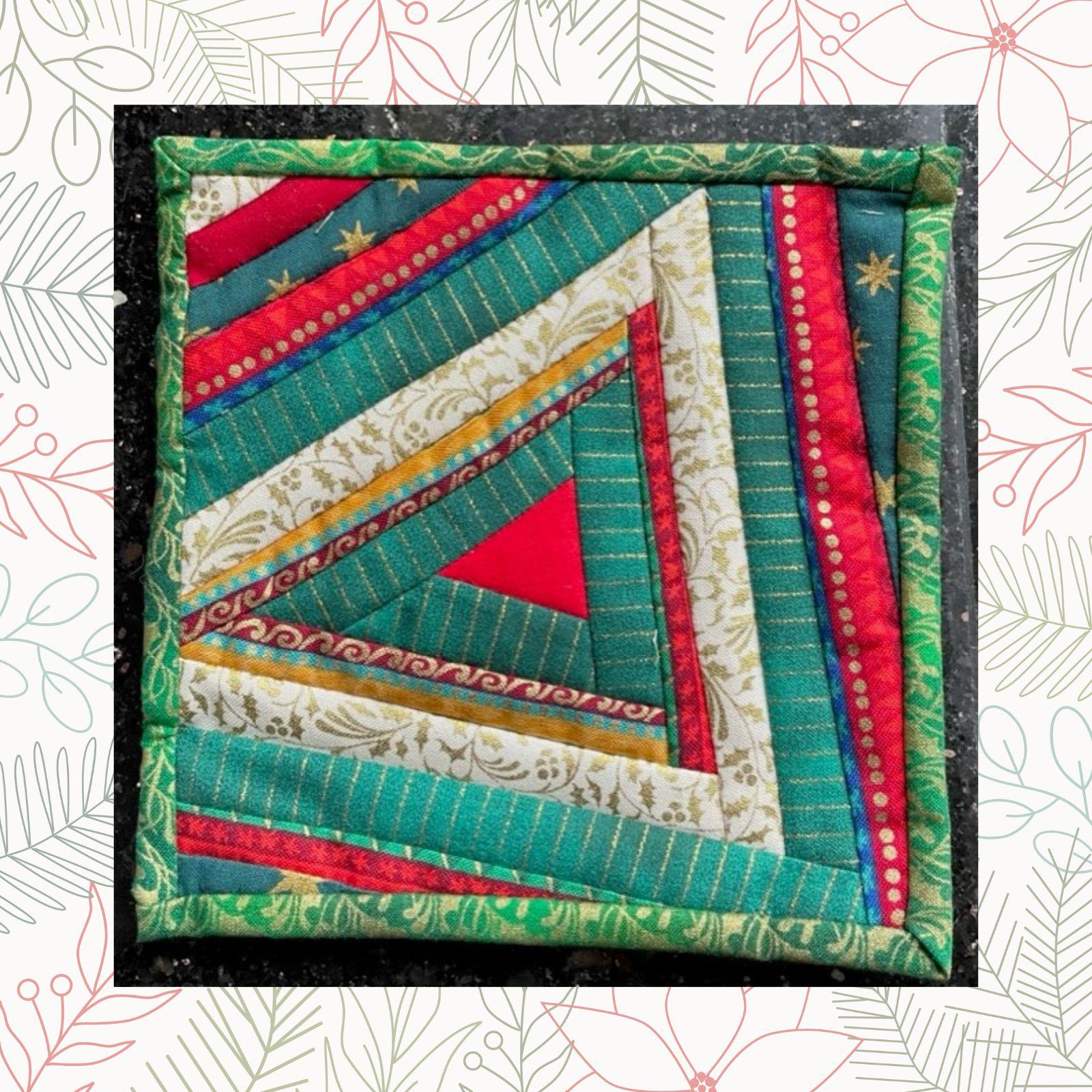 A square quilt with a colorful, geometric design. The quilt features triangles in various colors, including red, green, gold, and white. The triangles are arranged in a radial pattern, creating a dynamic and visually interesting composition.