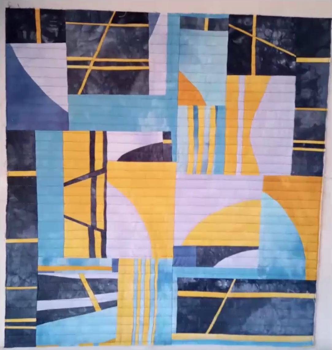 Improv quilt piece in the style of Irene Roderick dancing with the wall in blues, whites and yellows