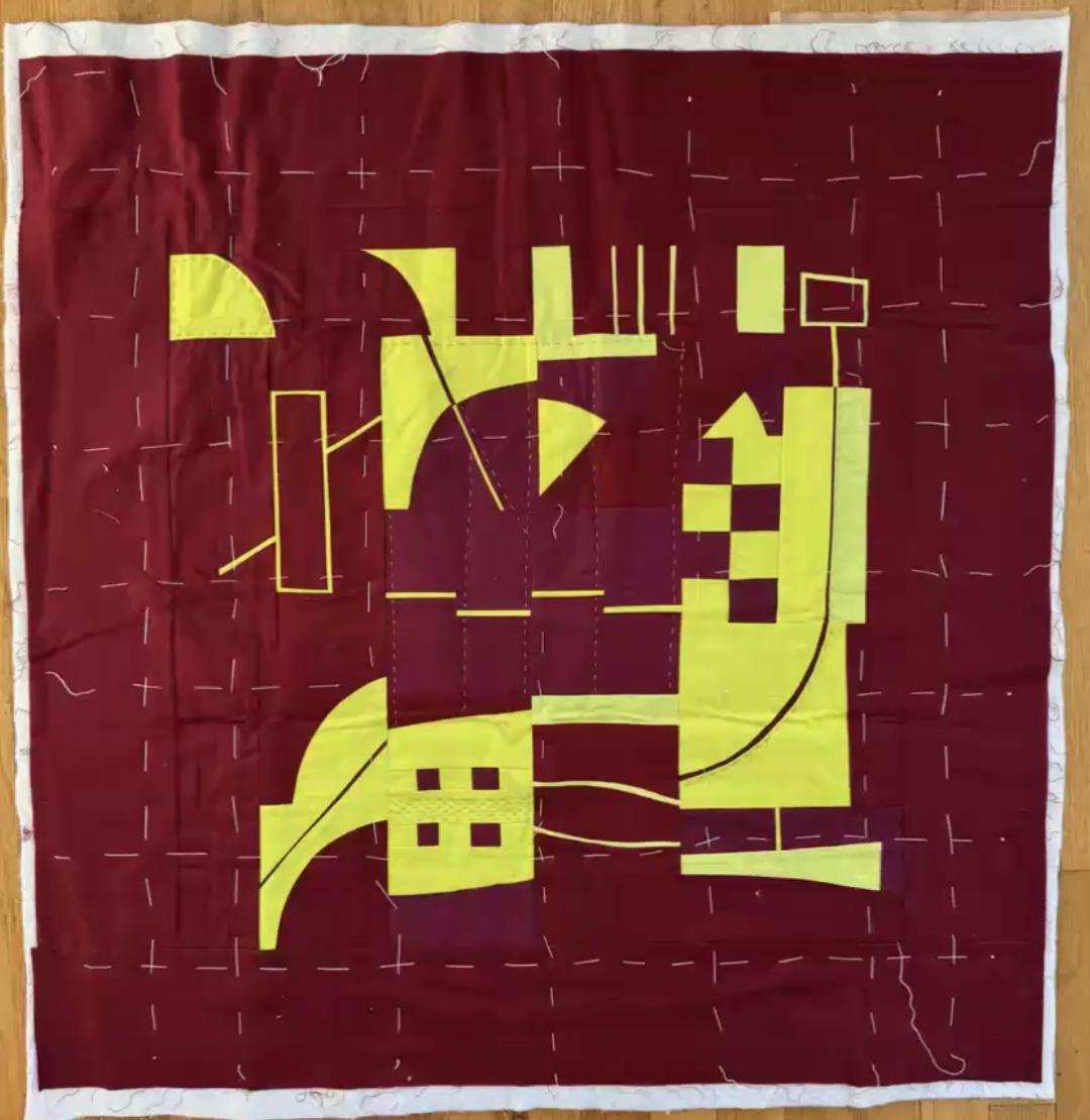 Improv quilt piece in the style of Irene Roderick dancing with the wall in burgundy and yellow