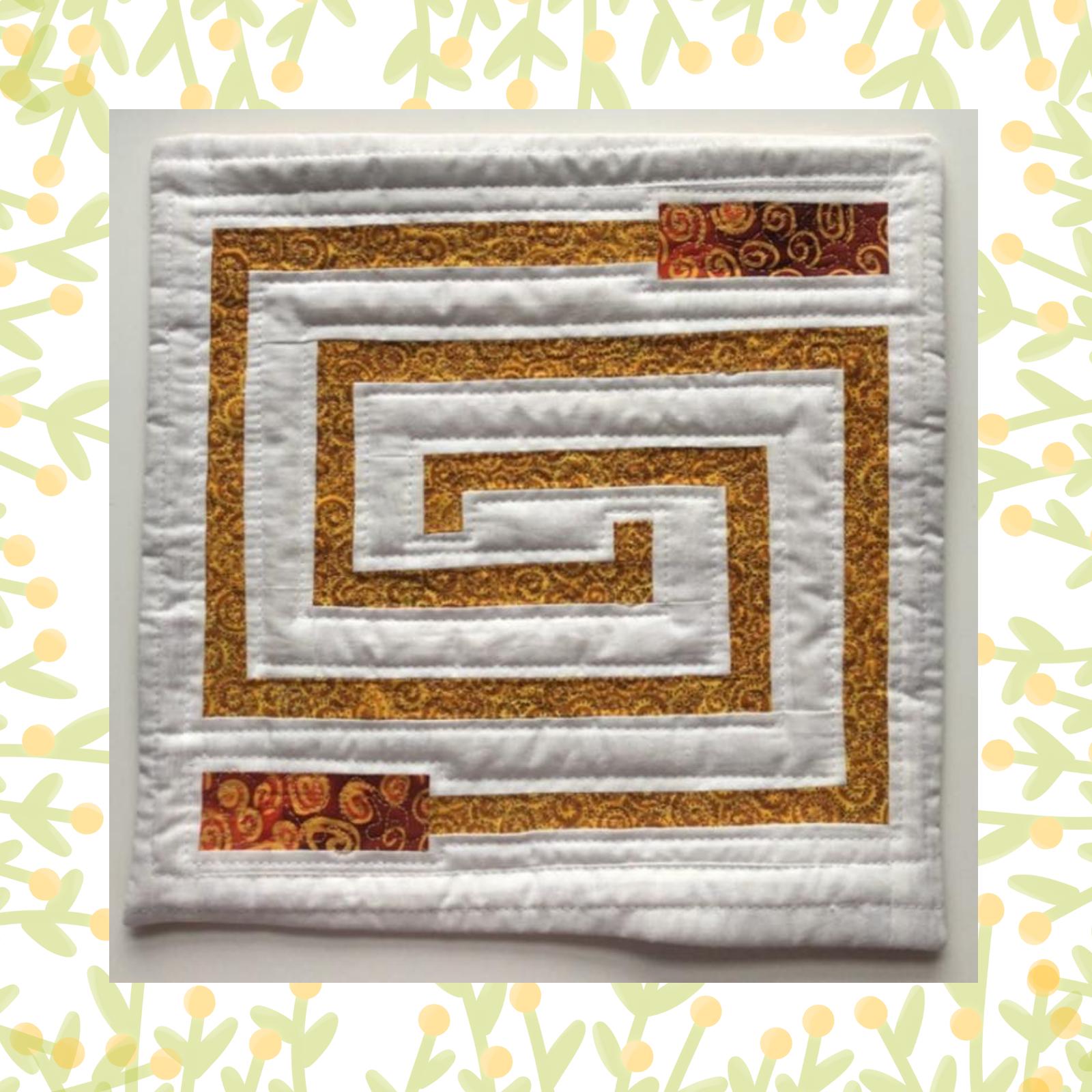 A square quilt with a white background. The quilt features a large, intricate maze design made up of gold and orange fabric strips. The maze is echoed in the quilting pattern, with thin lines following the path of the maze.