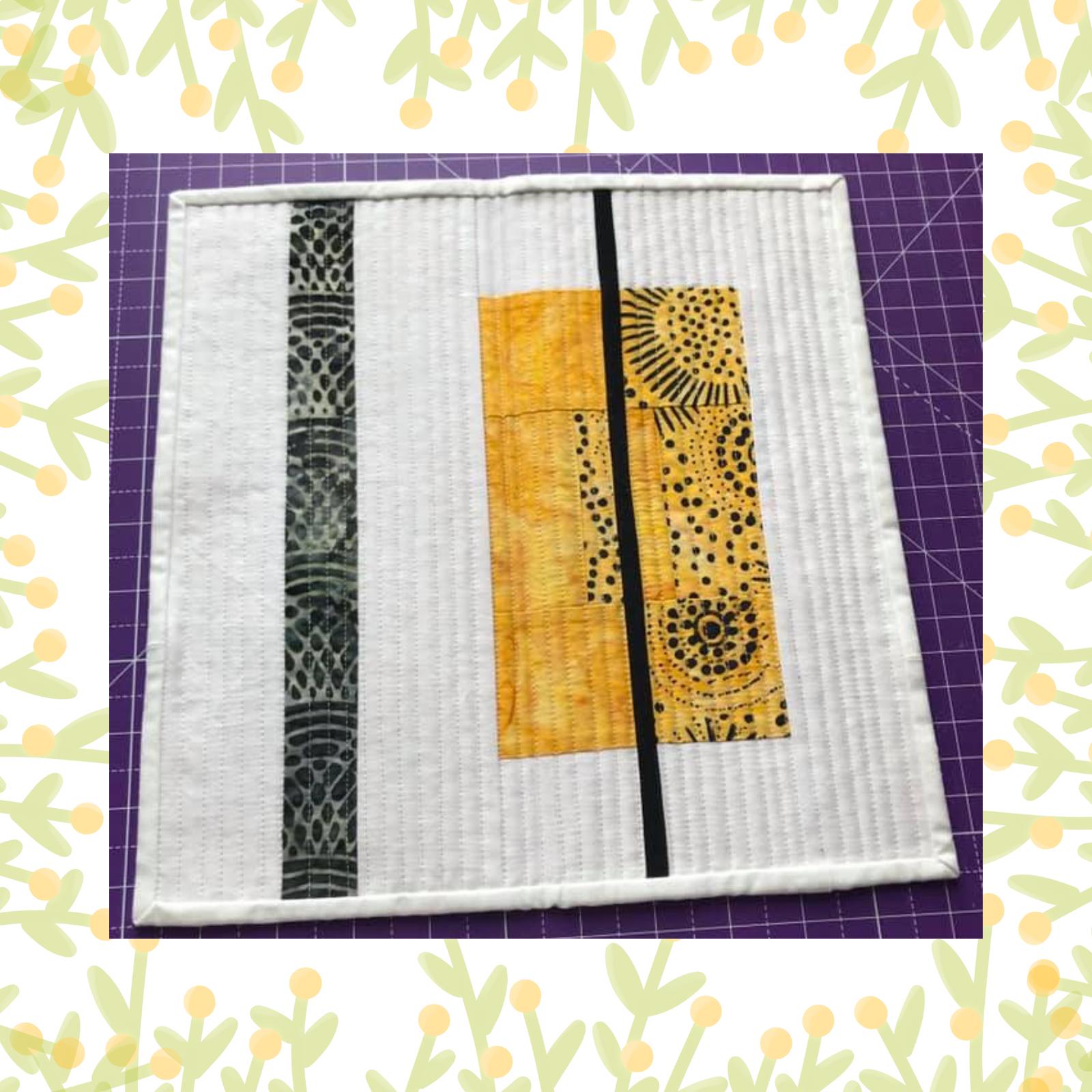 A square quilt with a white background and a yellow border. The quilt features a minimalist design with vertical black stripes and a yellow rectangle in the centre. The rectangle is decorated with a pattern of small circles. The background is quilted with vertical lines.