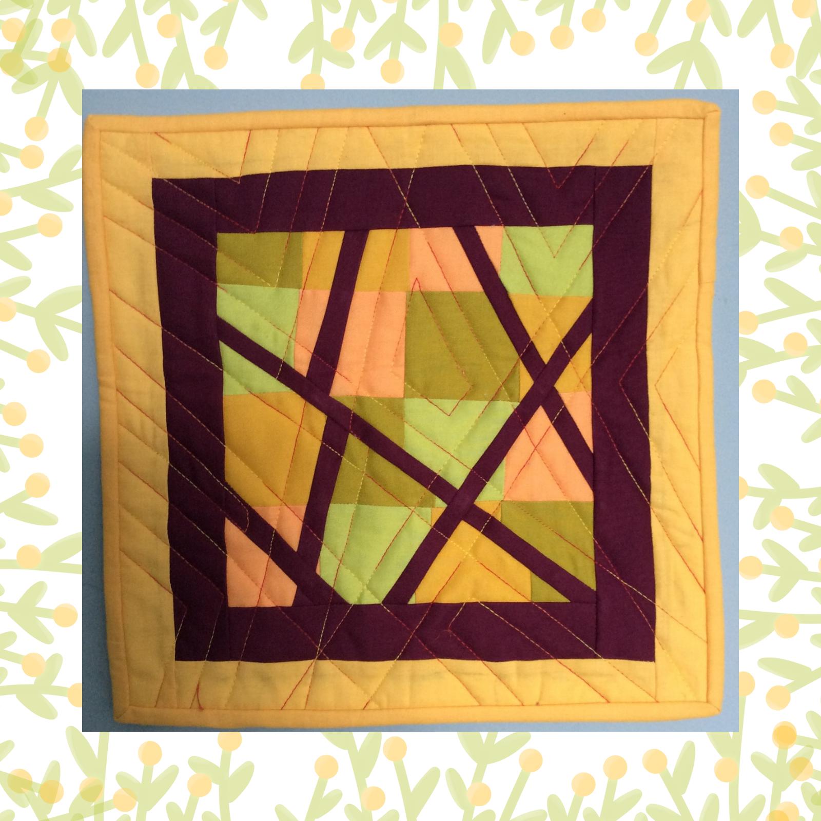 A square quilt with a yellow background and a purple border. The quilt features a geometric design with squares and triangles in shades of yellow, green, and pink. The shapes are intersected by purple lines, creating a dynamic composition. The background is quilted with a linear pattern.
