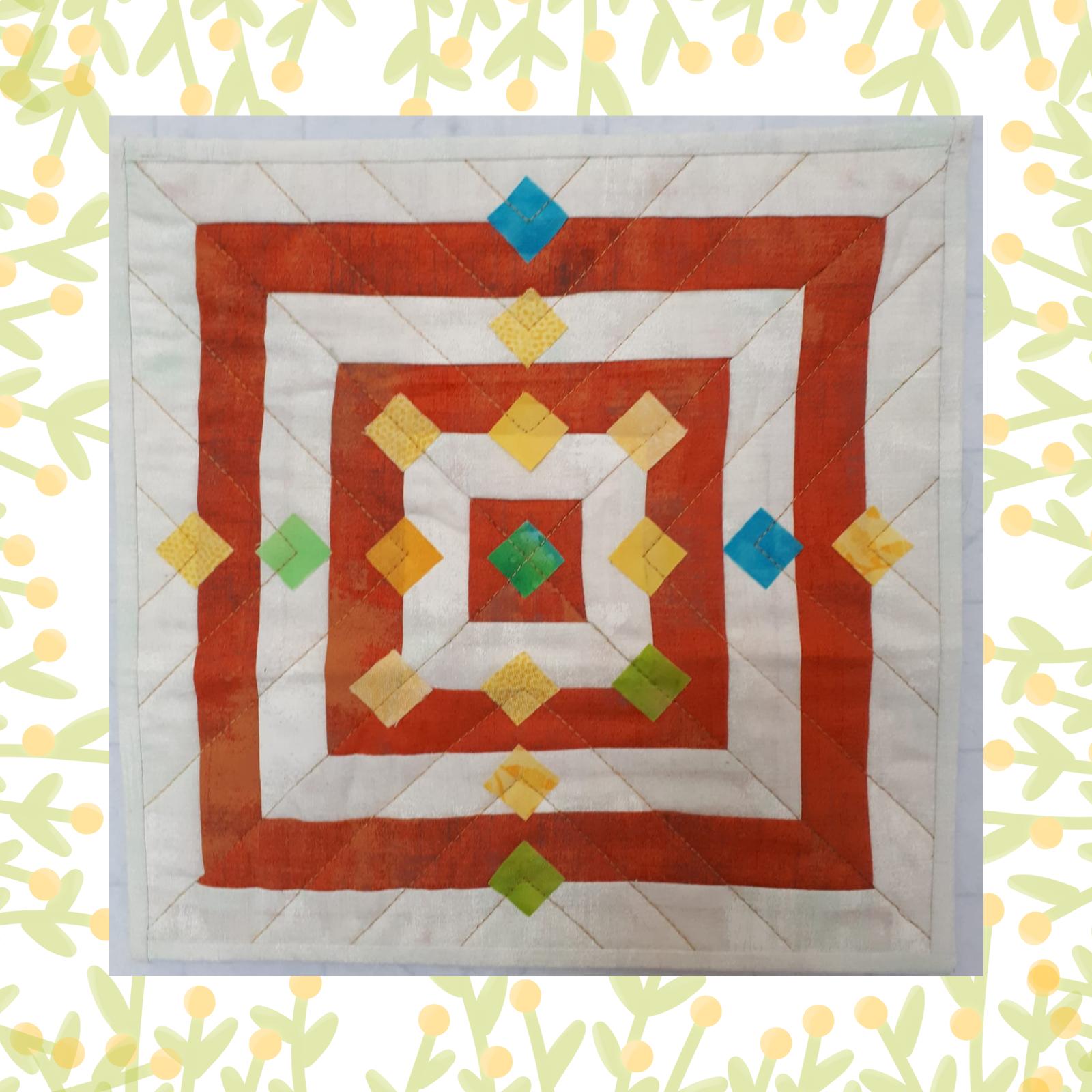 A square quilt with a red background and a white border. The quilt features a geometric design with multiple squares of varying sizes, each with a different coloured diamond shape in the centre. The colours include red, orange, yellow, green, and blue. The background is quilted with a linear pattern.