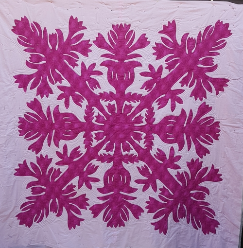 Quilt by Pippa Moss. Pink damask style pattern on white background